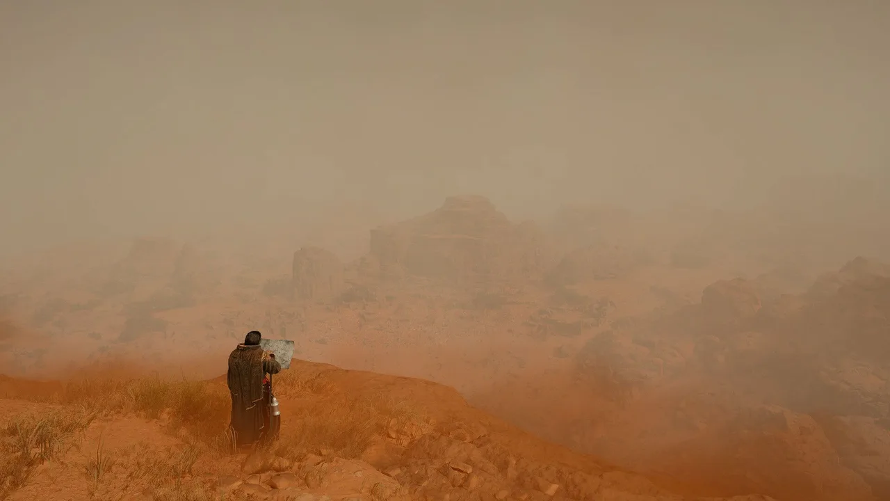 Crimson Desert: egy köpenyes figura áll egy ködös, sivatagi sziklapárkányon és a távolba néz.
